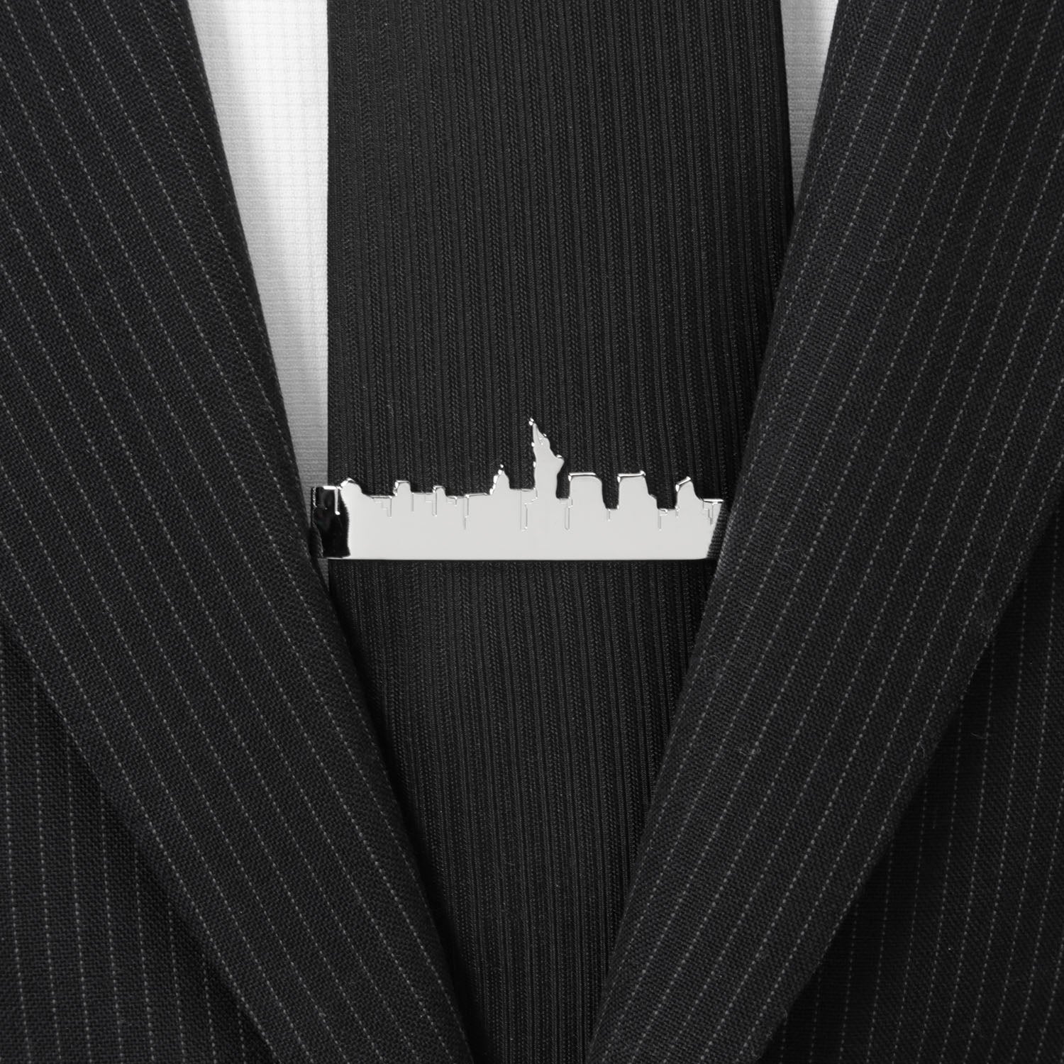 Black pinstripe suit jacket with a silver tie clip featuring a city skyline.