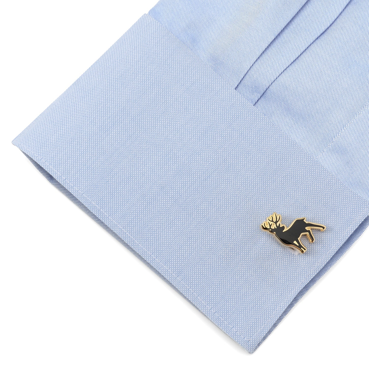 Gold dog-shaped cufflink on a light blue dress shirt