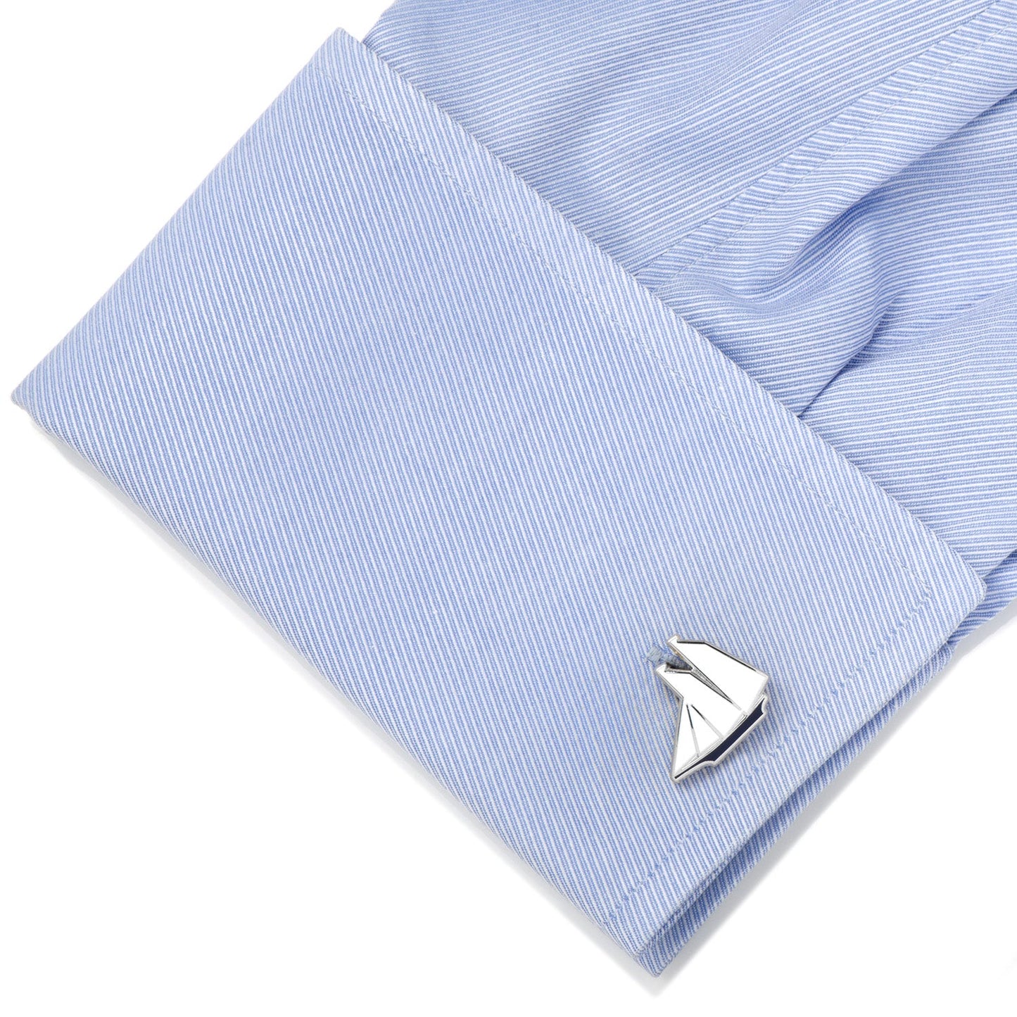 Silver sailboat cufflinks on a light blue dress shirt