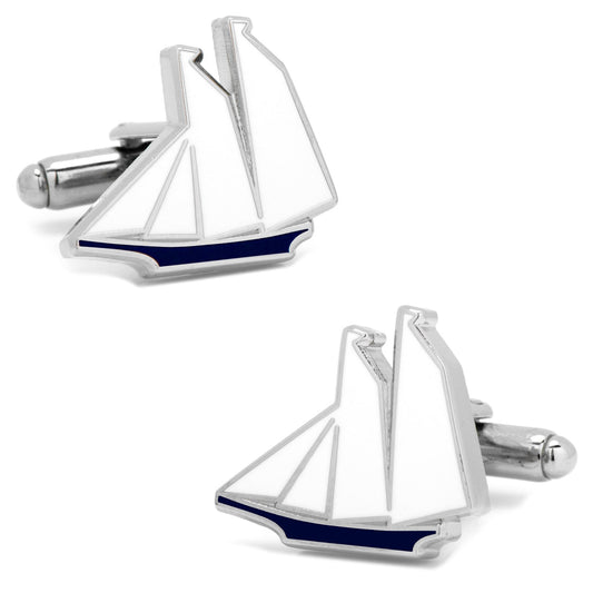 Sailboat-shaped cufflinks with blue accents on a white background