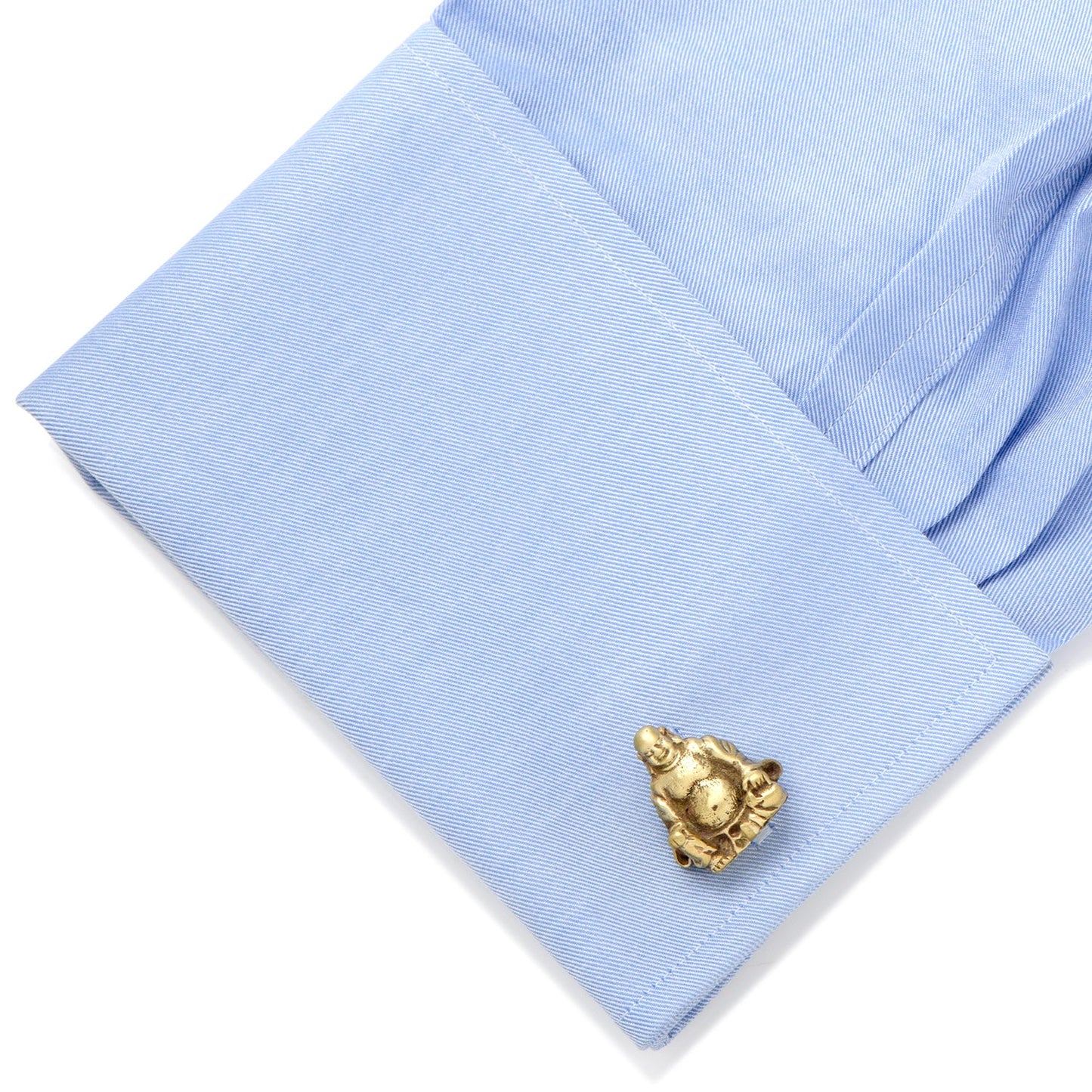 Gold cufflink on a light blue shirt cuff