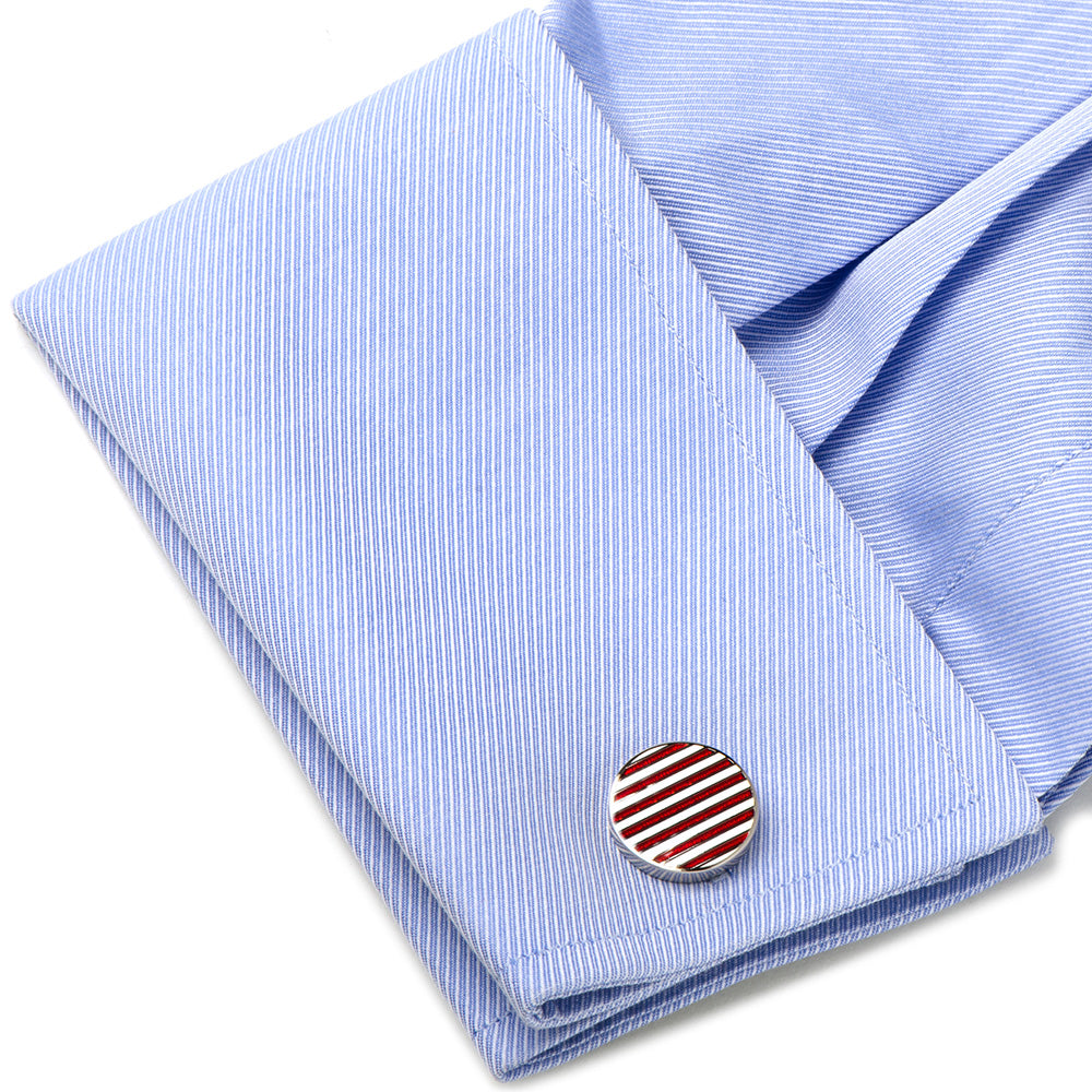 Cufflink on a blue striped shirt with a white background