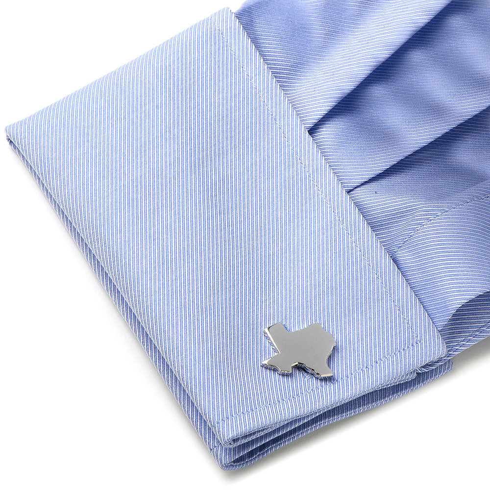 Blue striped shirt with a silver dog-shaped cufflink on a white background