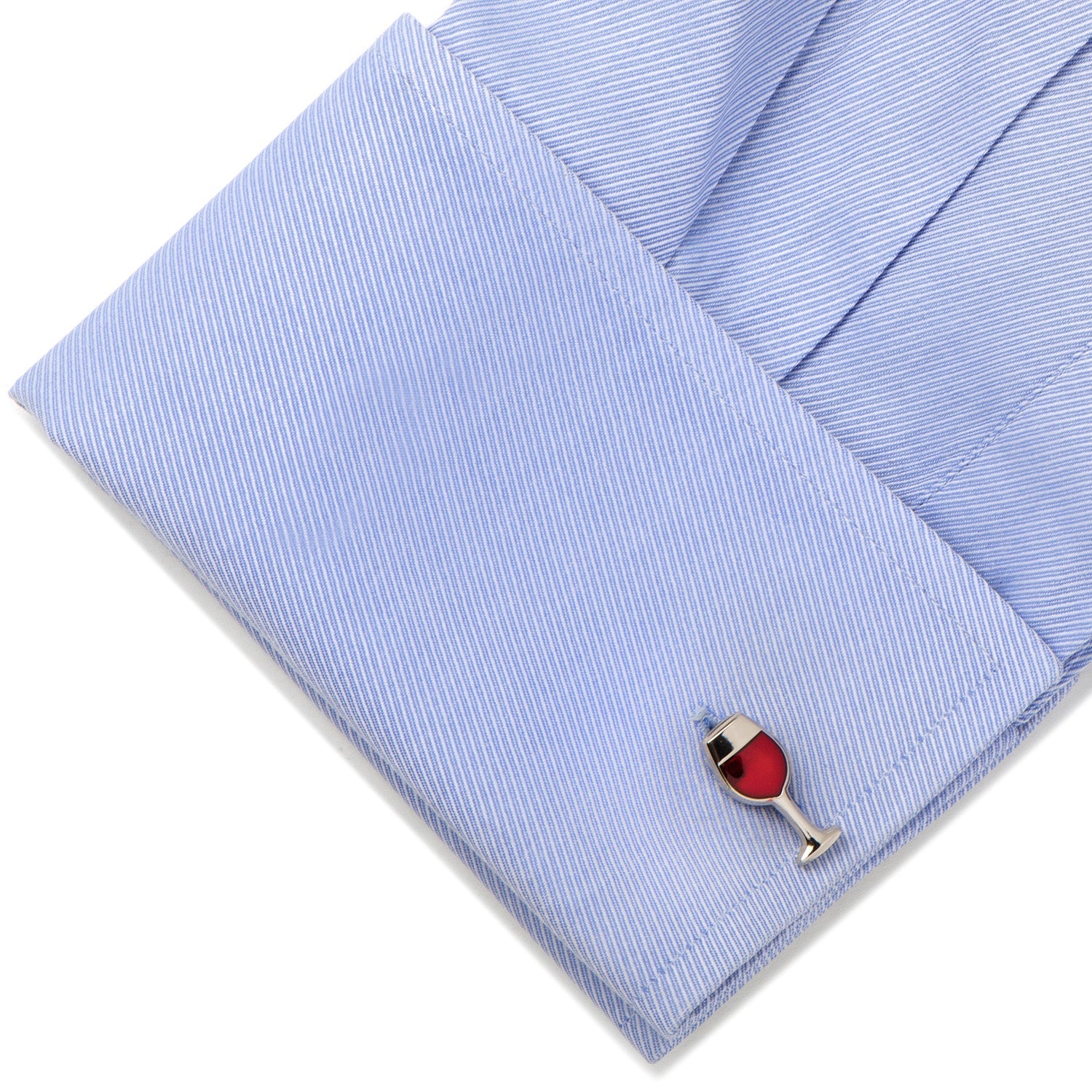 Cufflinks shaped like a wine glass with red gemstone on a light blue pocket square.