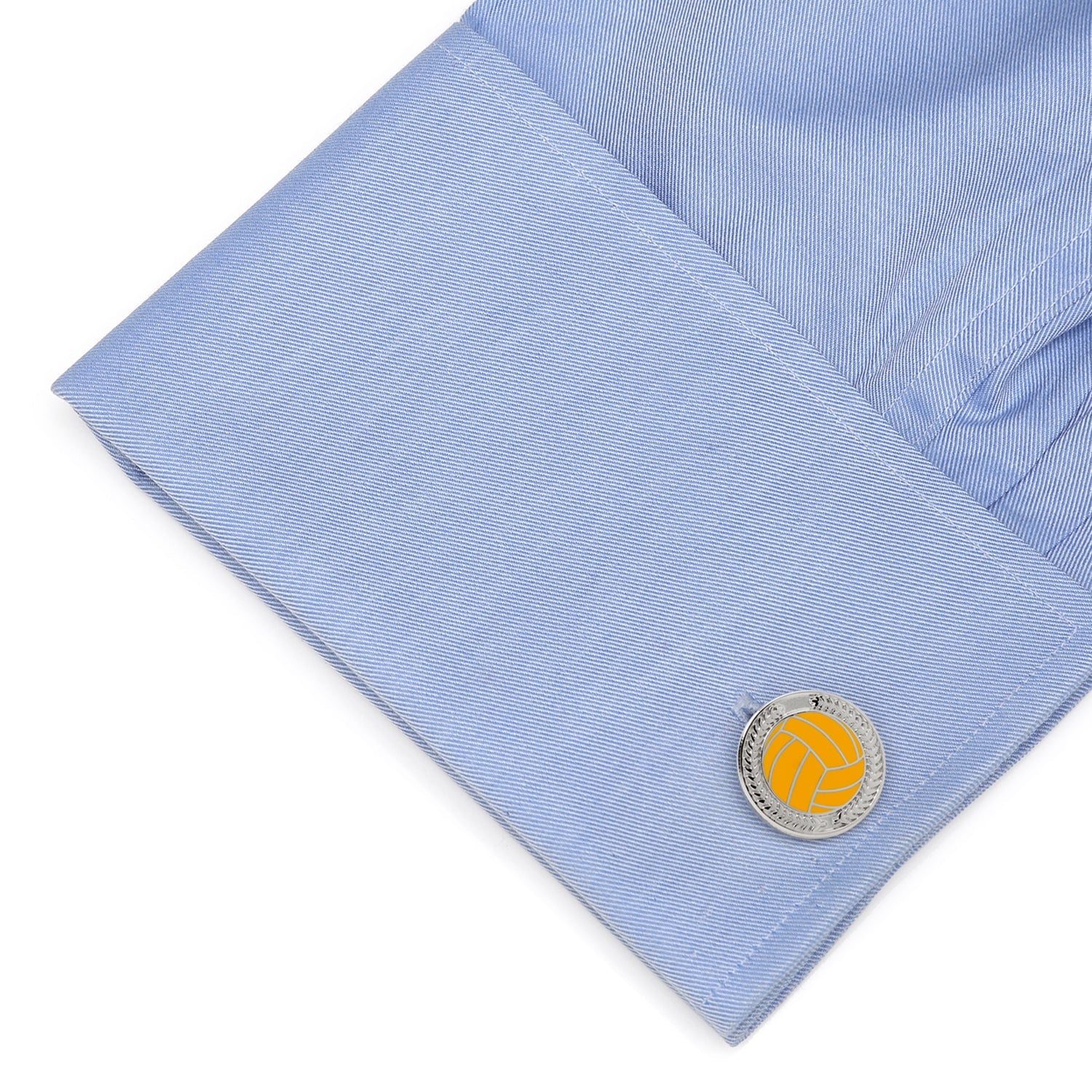 Close-up of a light blue shirt cuff with a round cufflink featuring a yellow circle and silver border.