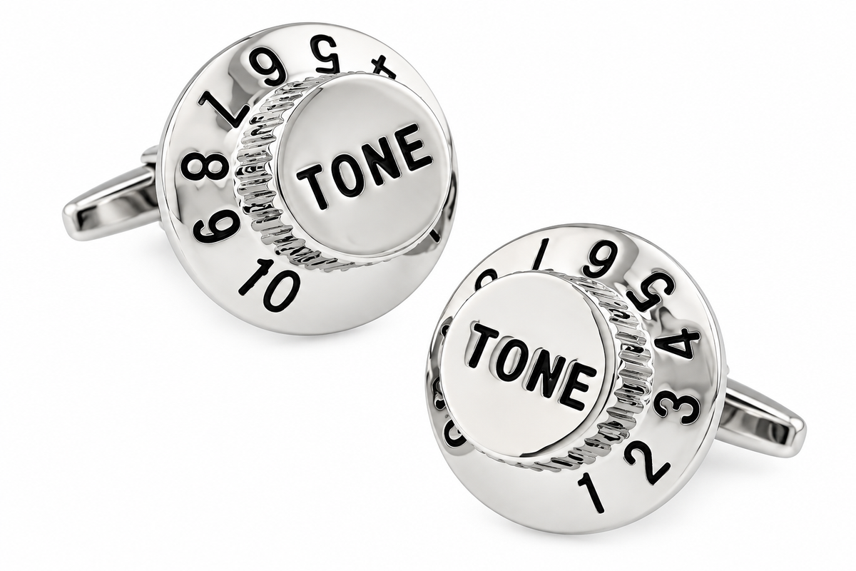 A pair of silver-toned round cufflinks designed to look like guitar tone controls, featuring engraved numbers and the word 'TONE' in black on a white background.