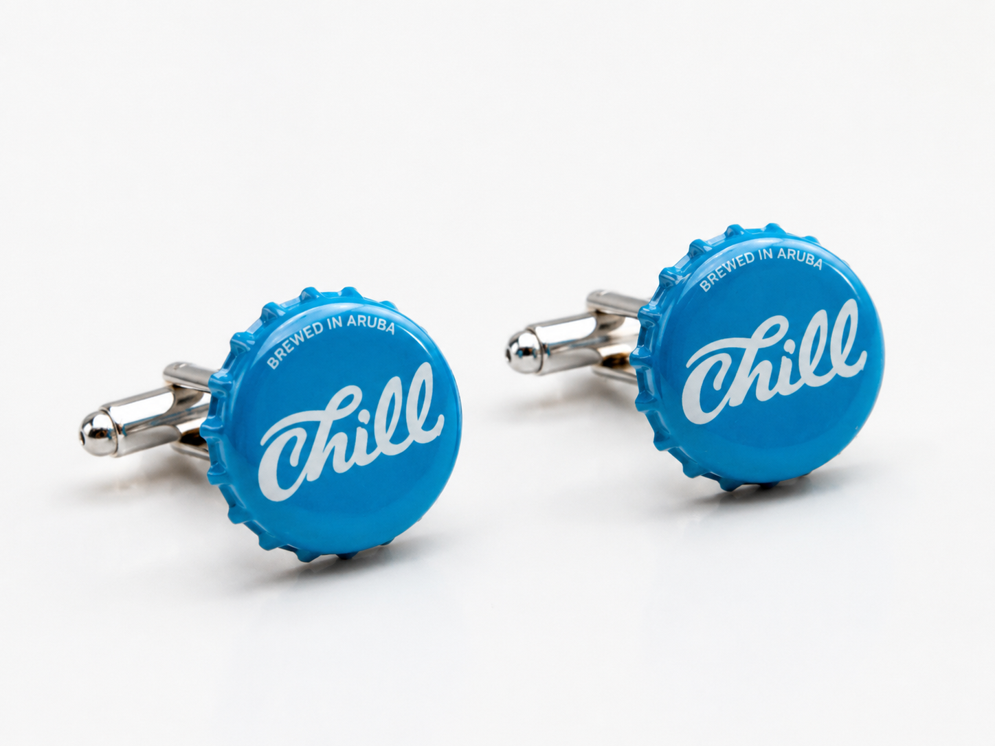 Authentic Aruba Chill Beer bottle cap cufflinks handmade with silver bullet back closures on a white background.