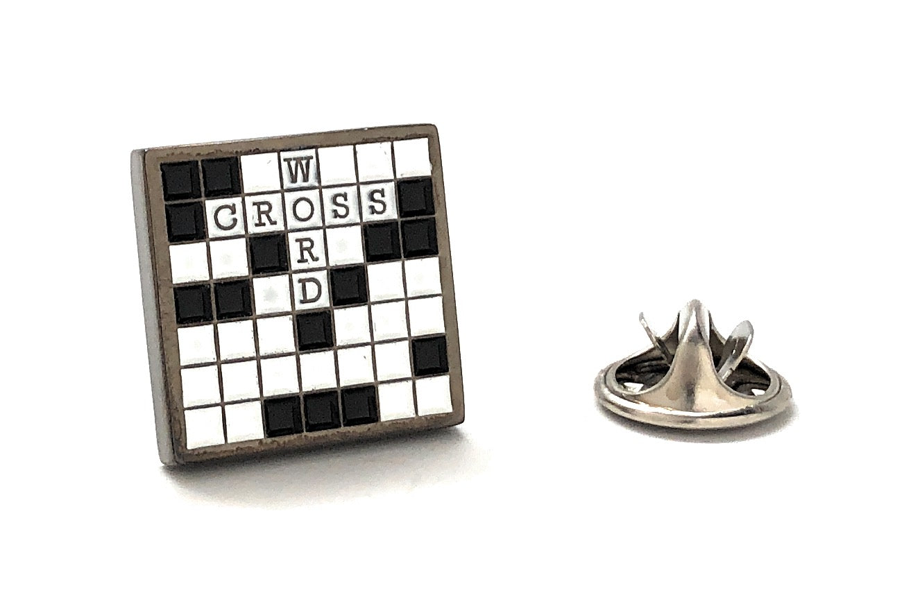 Black and white crossword puzzle lapel pin with raised letters and metal clutch backing