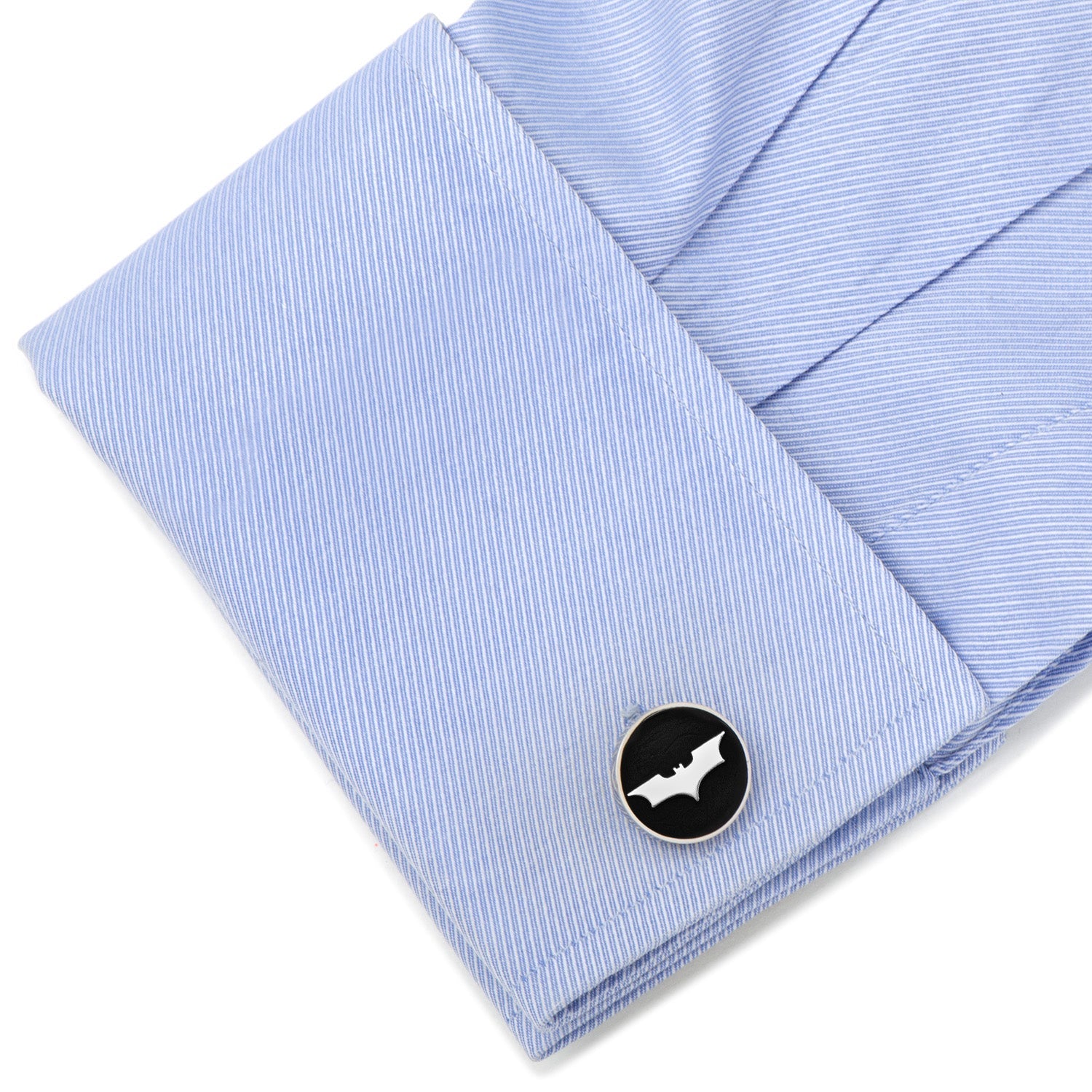 Cufflink with bat design on a light blue shirt