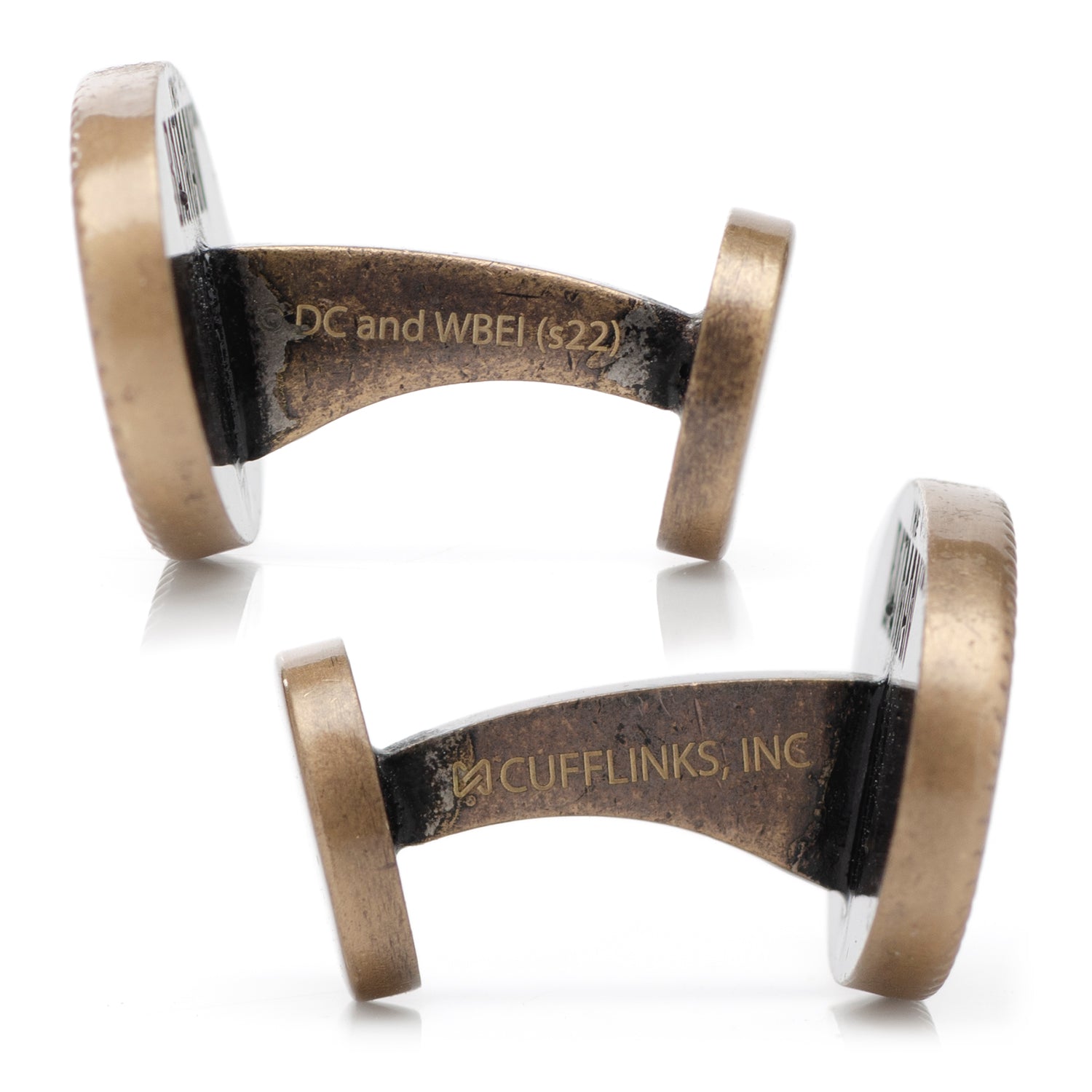 Pair of bronze cufflinks with engraved text on a white background