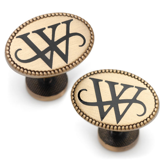 Two brass cabinet knobs with a black logo on a white background