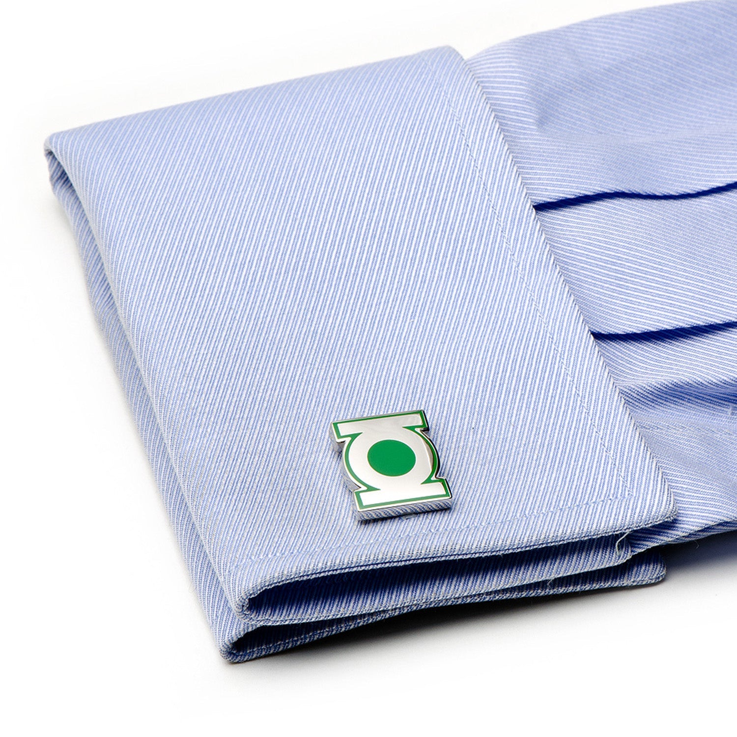 Folded blue striped shirt with a green emblem on a white background