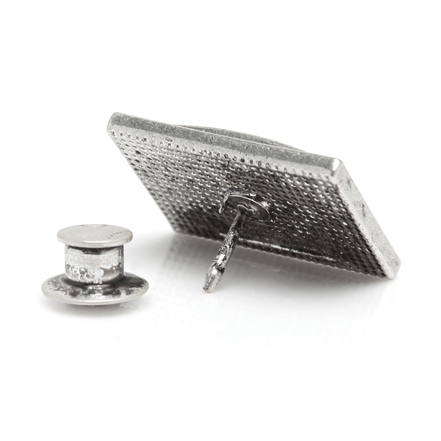 Silver textured square brooch on a white background