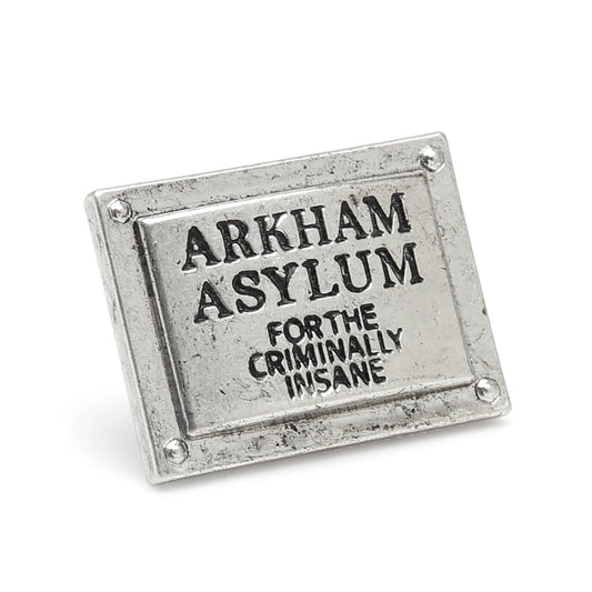 Metal sign with 'Arkham Asylum' text on a white background