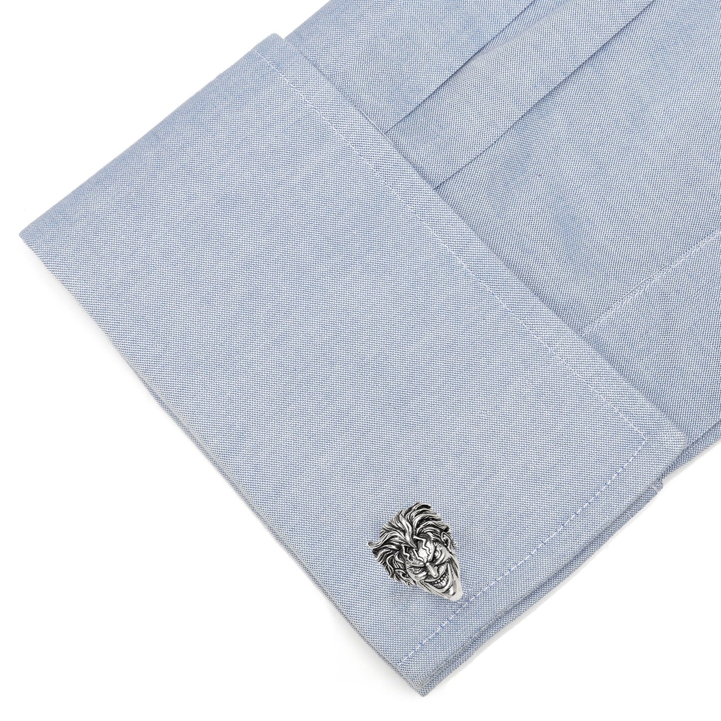 Cufflink on a light blue pocket square with a white background