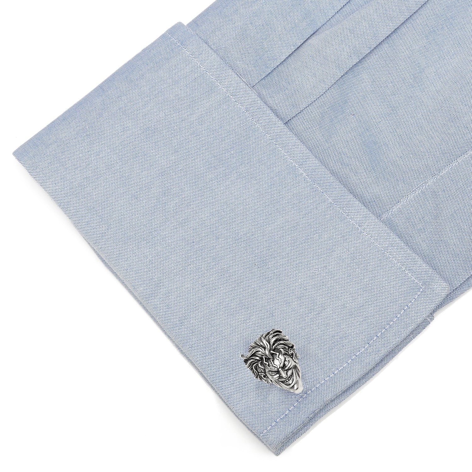 Cufflink on a light blue pocket square with a white background
