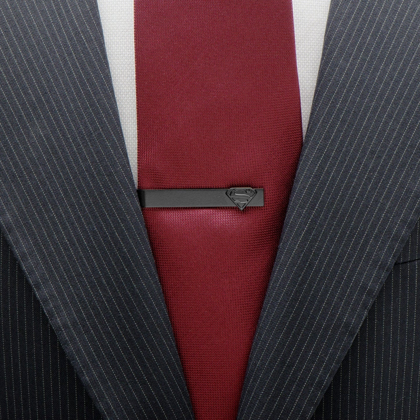 Gray pinstripe suit with a red tie and Superman tie clip