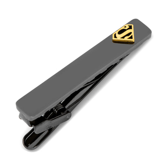 Black tie clip with gold Superman logo on a white background