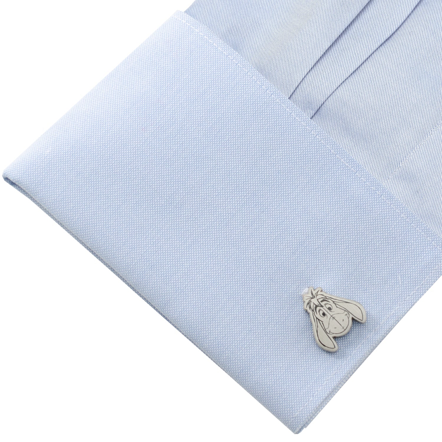 Cufflink on a light blue dress shirt