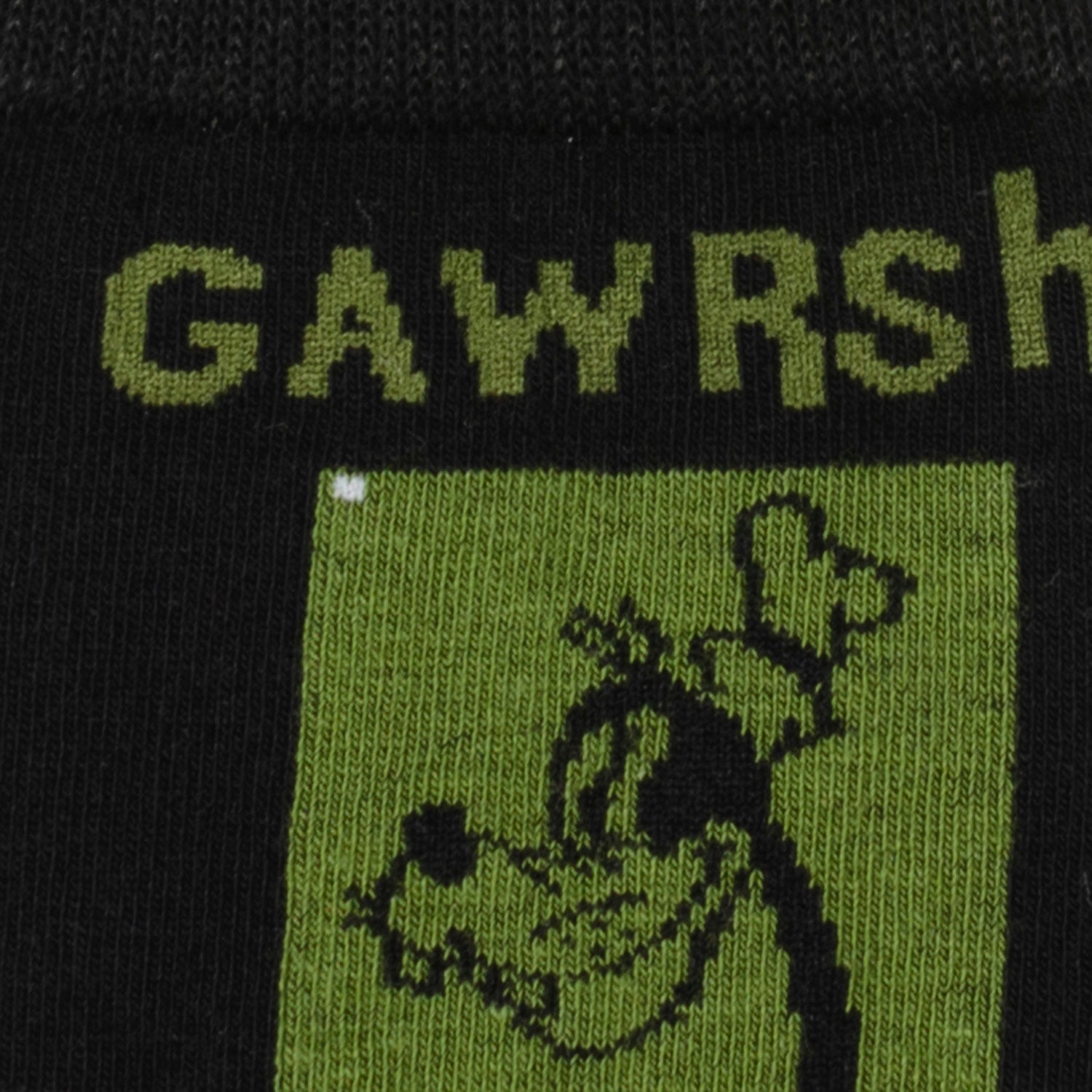 Close-up of a product with text and a graphic on a green and black background