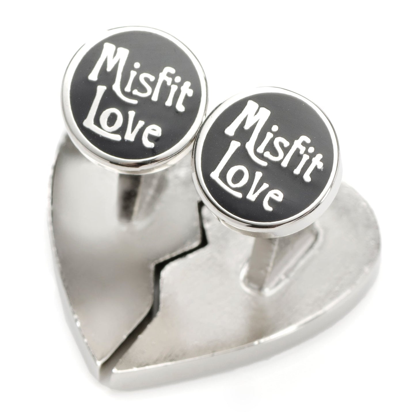 Heart-shaped silver ring with 'Misfit Love' on black stones against a white background
