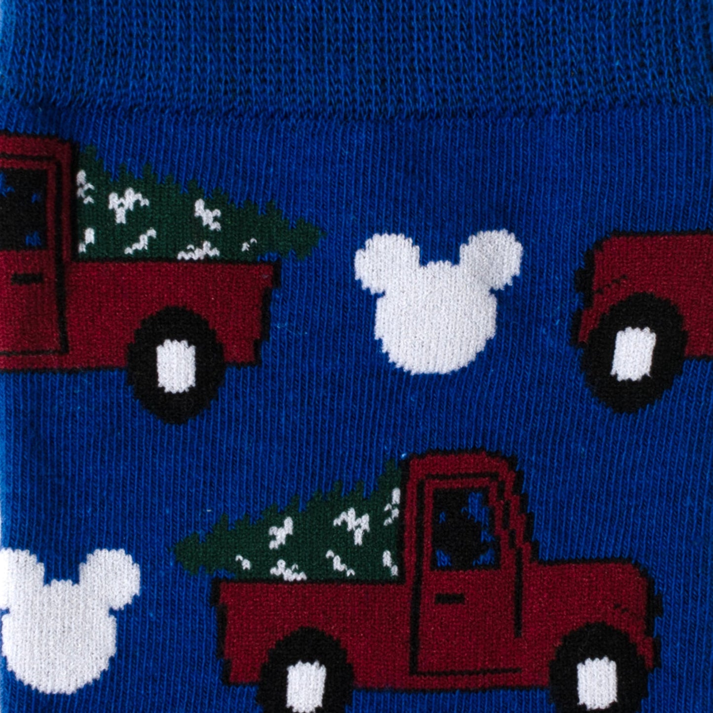 Socks with red trucks carrying Christmas trees and white Mickey Mouse heads on a blue background