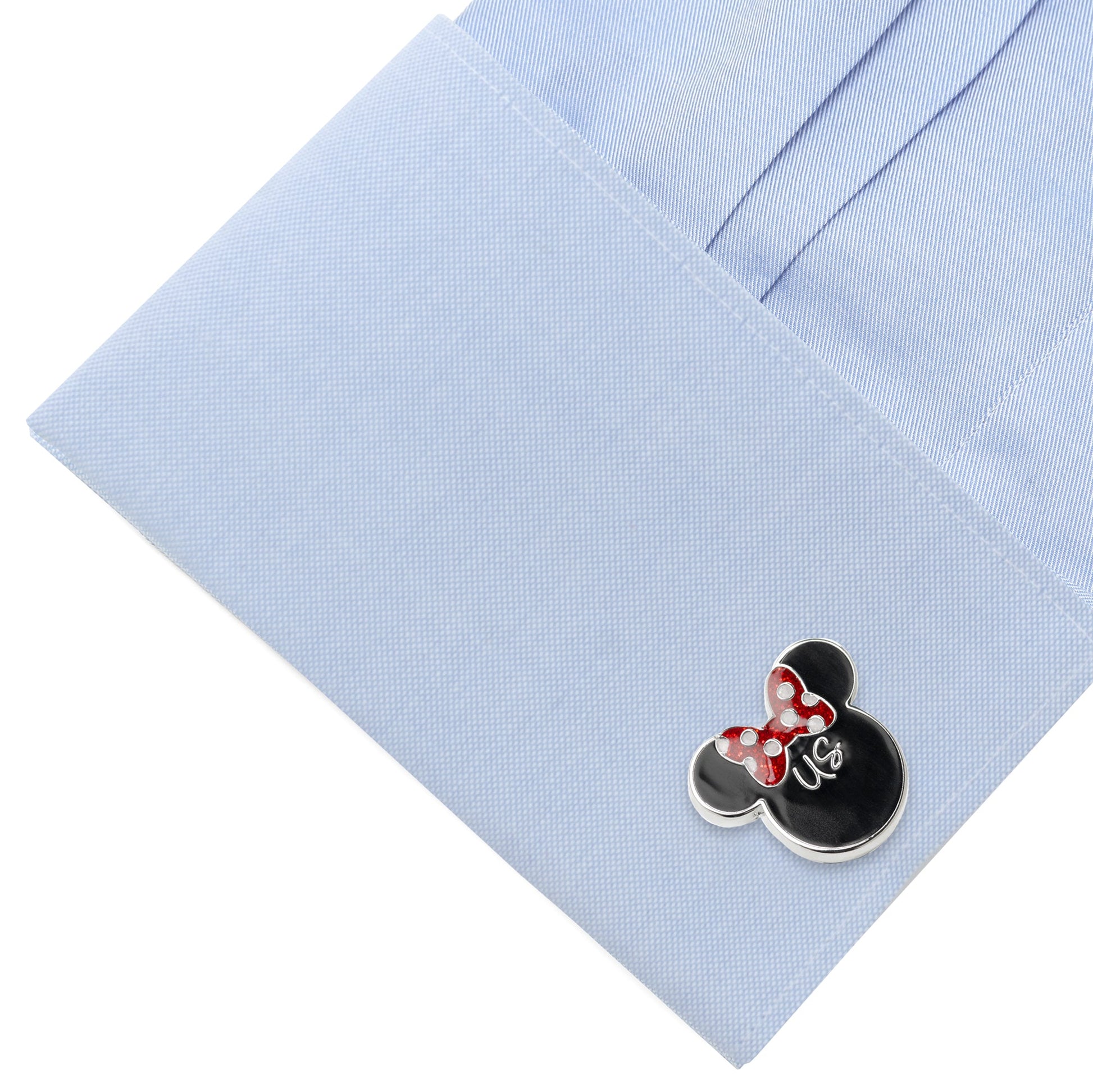 Cufflink with a cartoon character design on a light blue shirt
