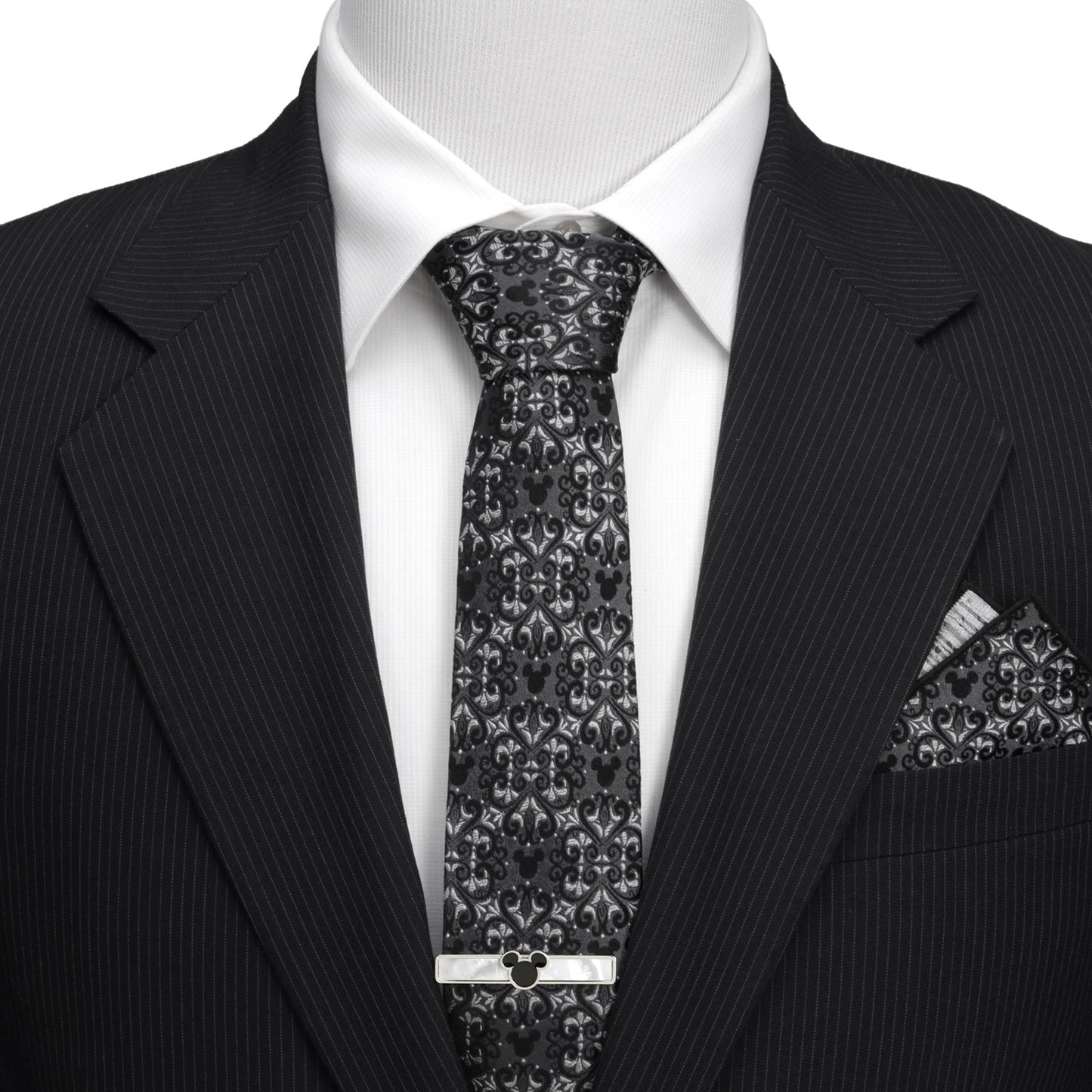 Black pinstripe suit with a patterned tie and pocket square on a mannequin. Hidden Mickey mouse 