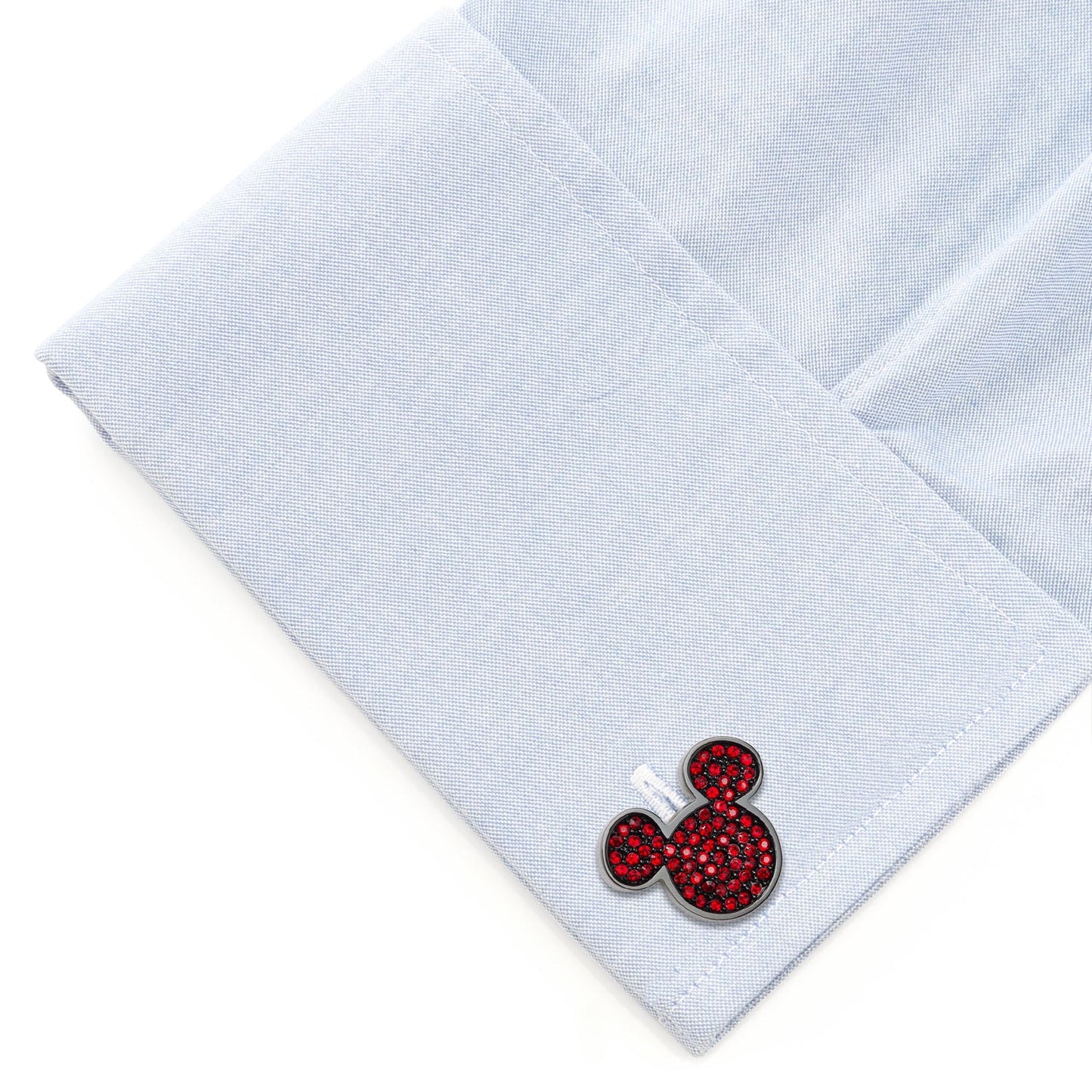 Cufflinks with a red and black design on a light blue shirt