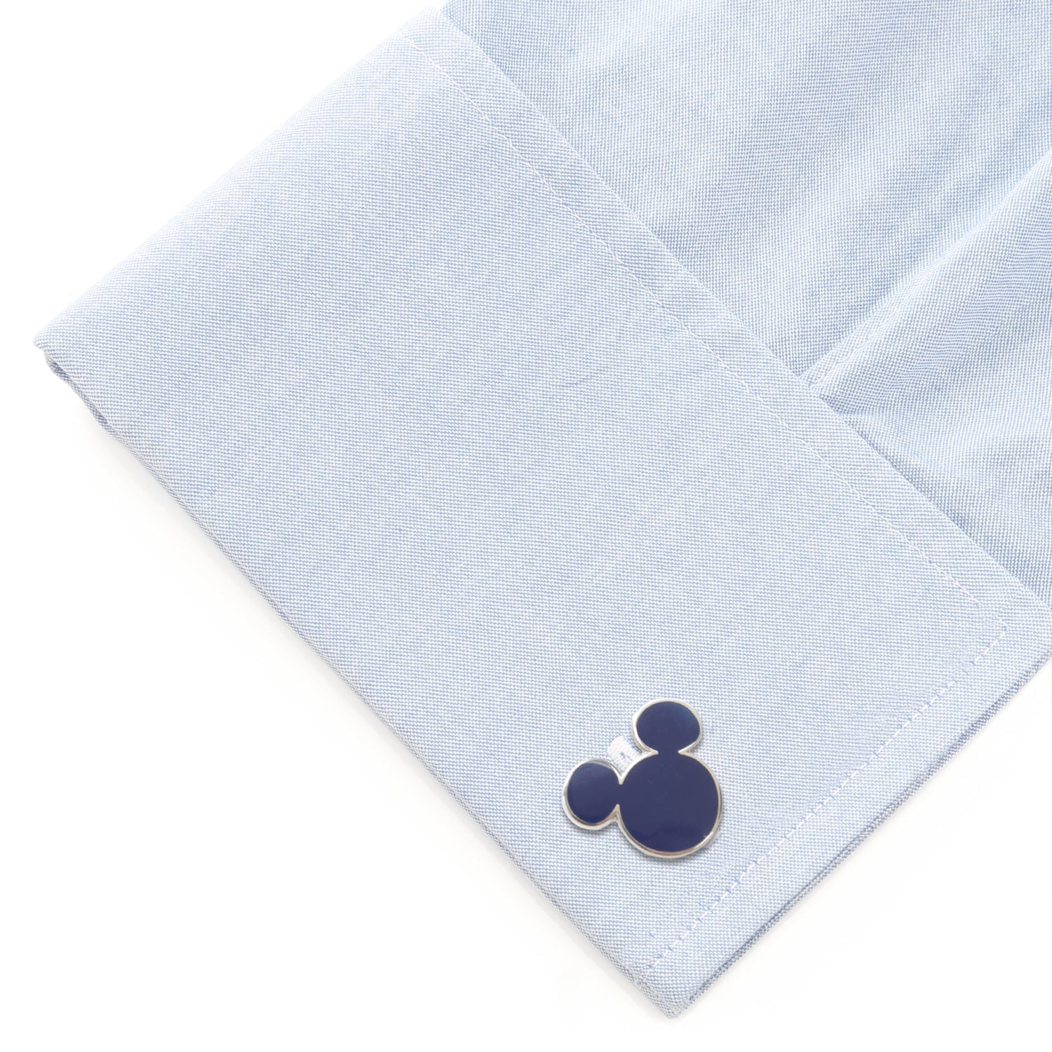 Navy blue Mickey Mouse cufflinks on a light blue dress shirt