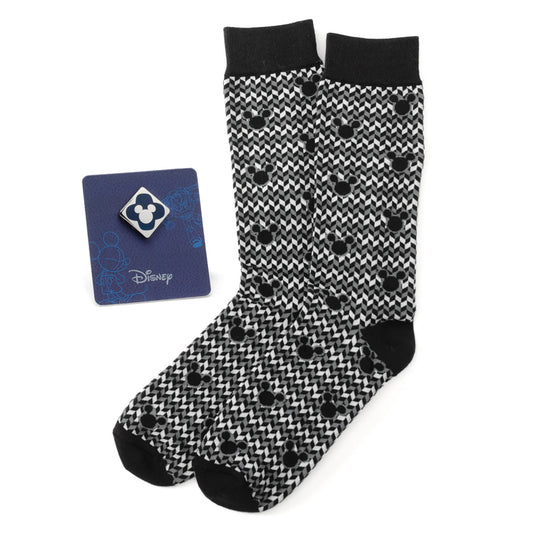 Black and white patterned socks with black toes and heels, featuring a Disney card on a white background.