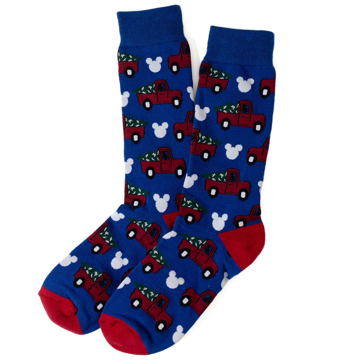Blue socks with red trucks and white trees pattern on a white background