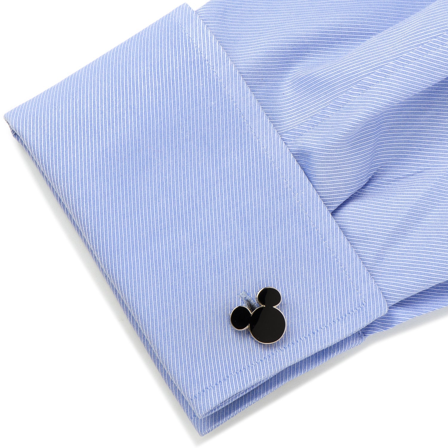 Cufflinks with a Mickey Mouse design on a light blue striped shirt