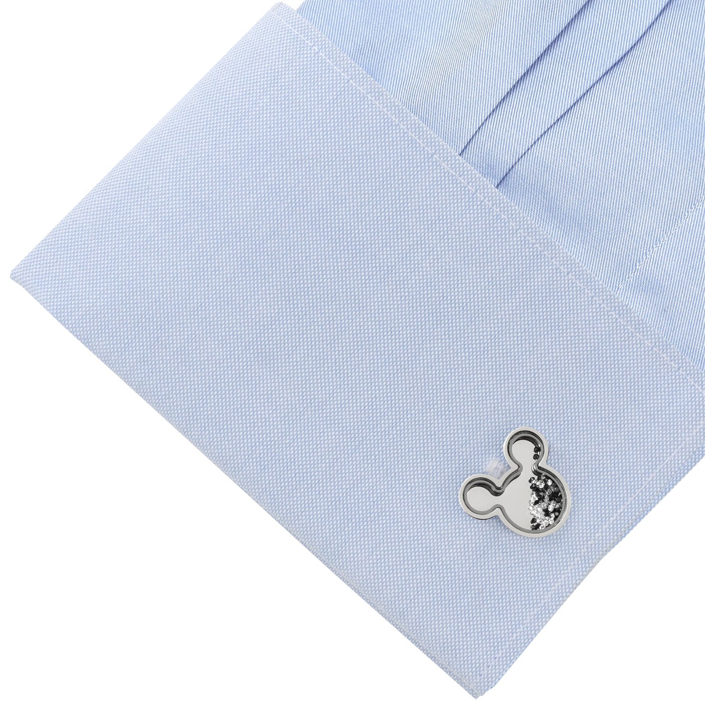 Cufflink on a light blue shirt cuff