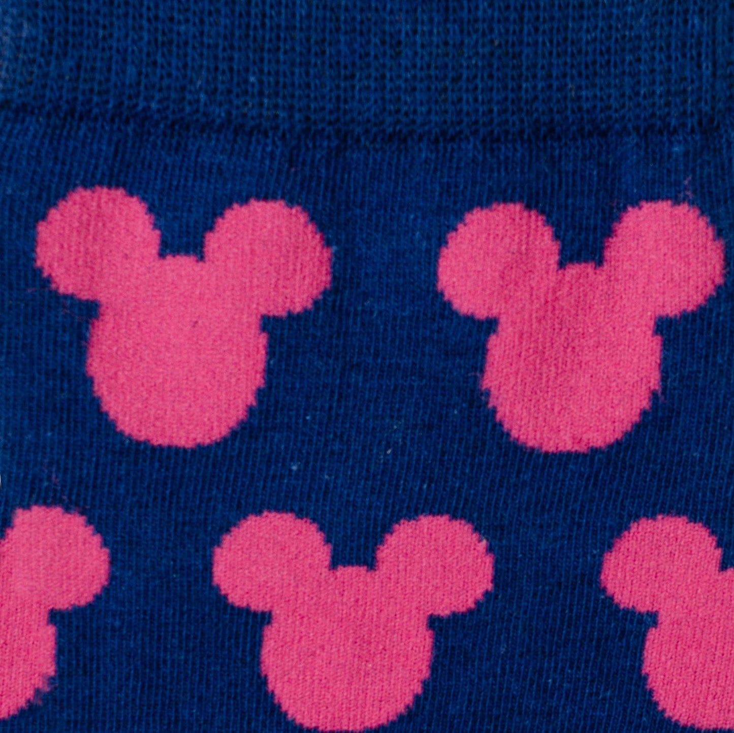 Pink Mickey Mouse ears pattern on a blue background