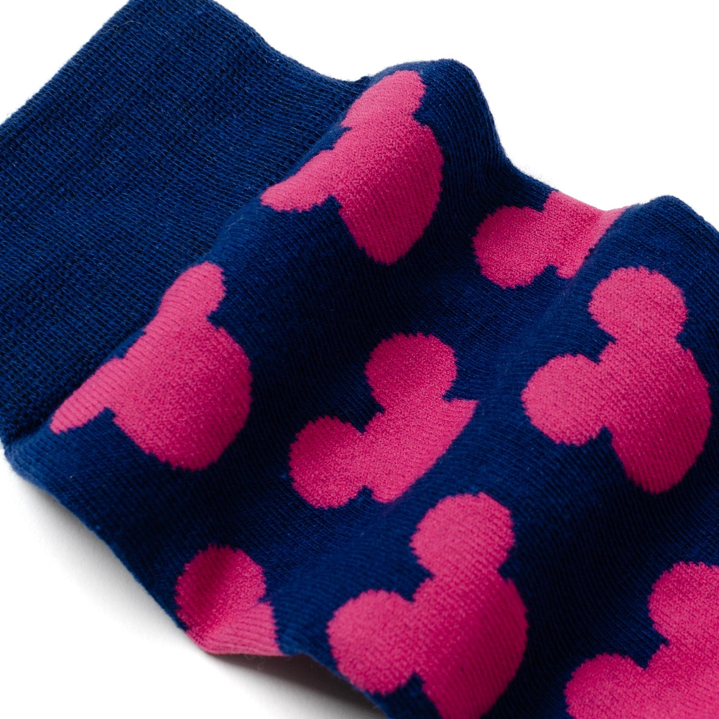Navy blue socks with pink Mickey Mouse heads on a white background