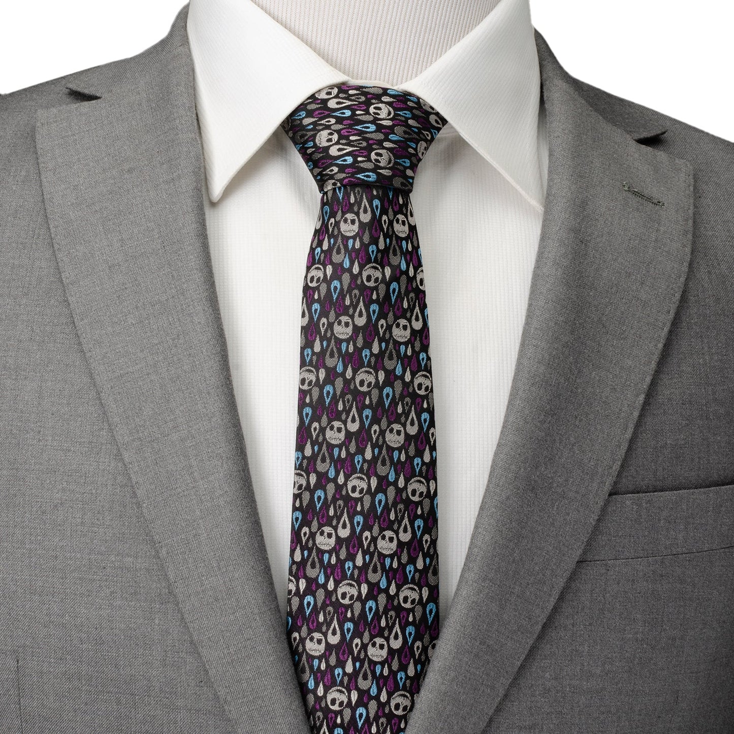 Gray suit with a white shirt and patterned tie on a white background
