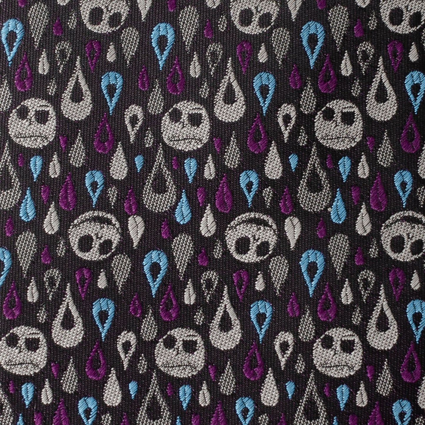 Pattern of stylized faces with teardrop shapes on a black background