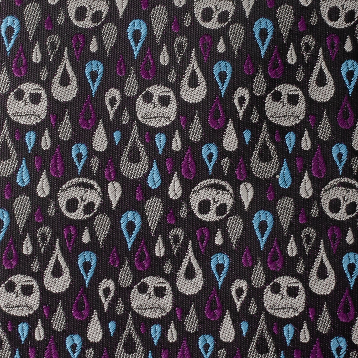 Pattern of stylized faces with teardrop shapes on a black background