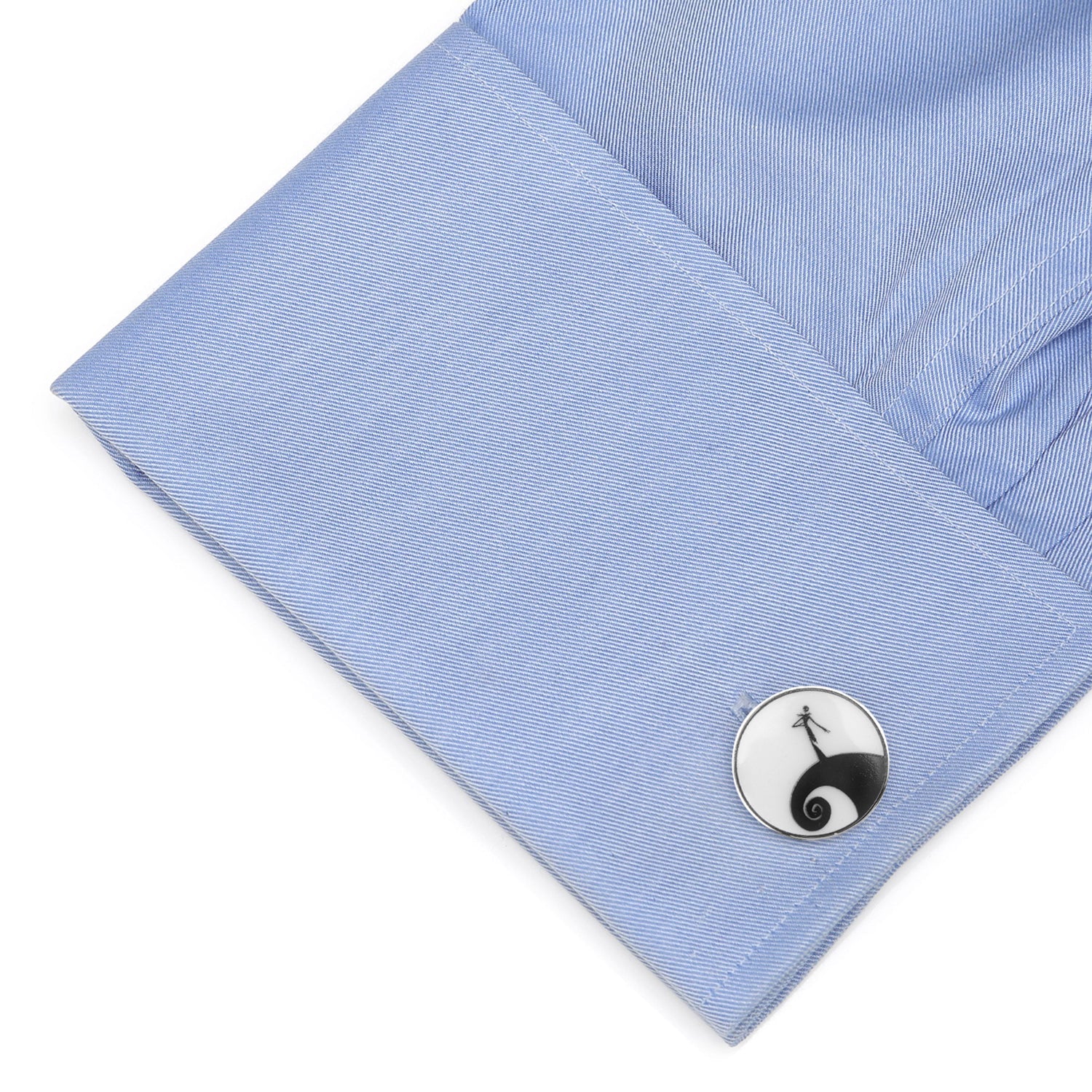 Cufflink on a blue shirt cuff