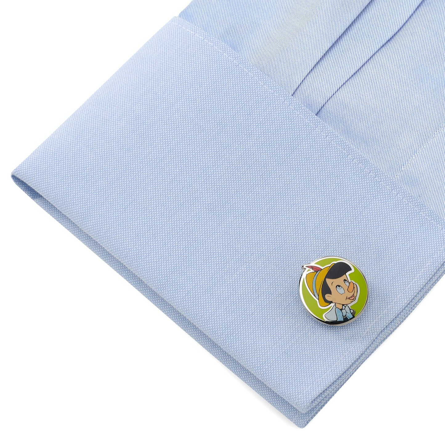 Pinocchio character pin on a light blue shirt