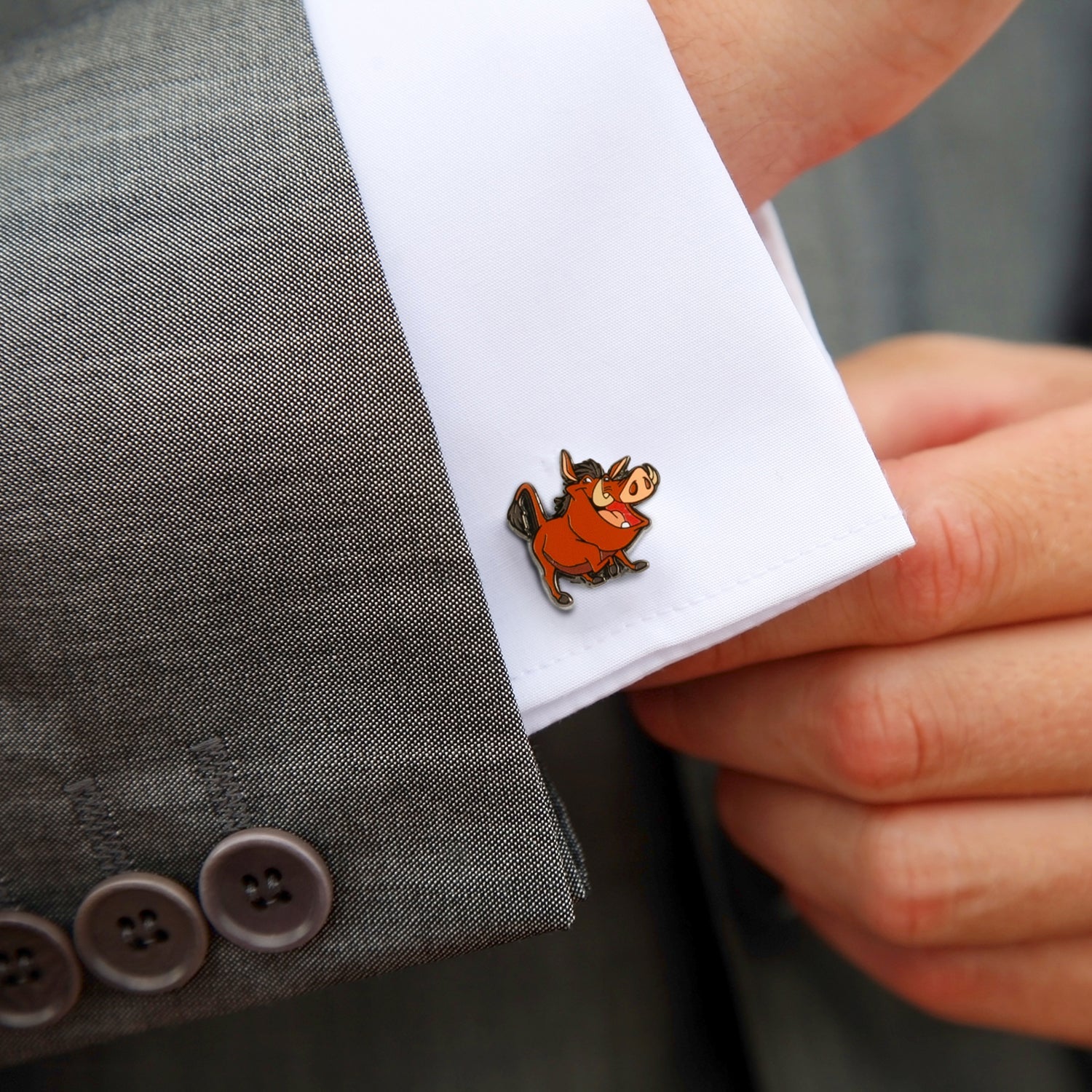 Cufflink with cartoon character on a suit cuff