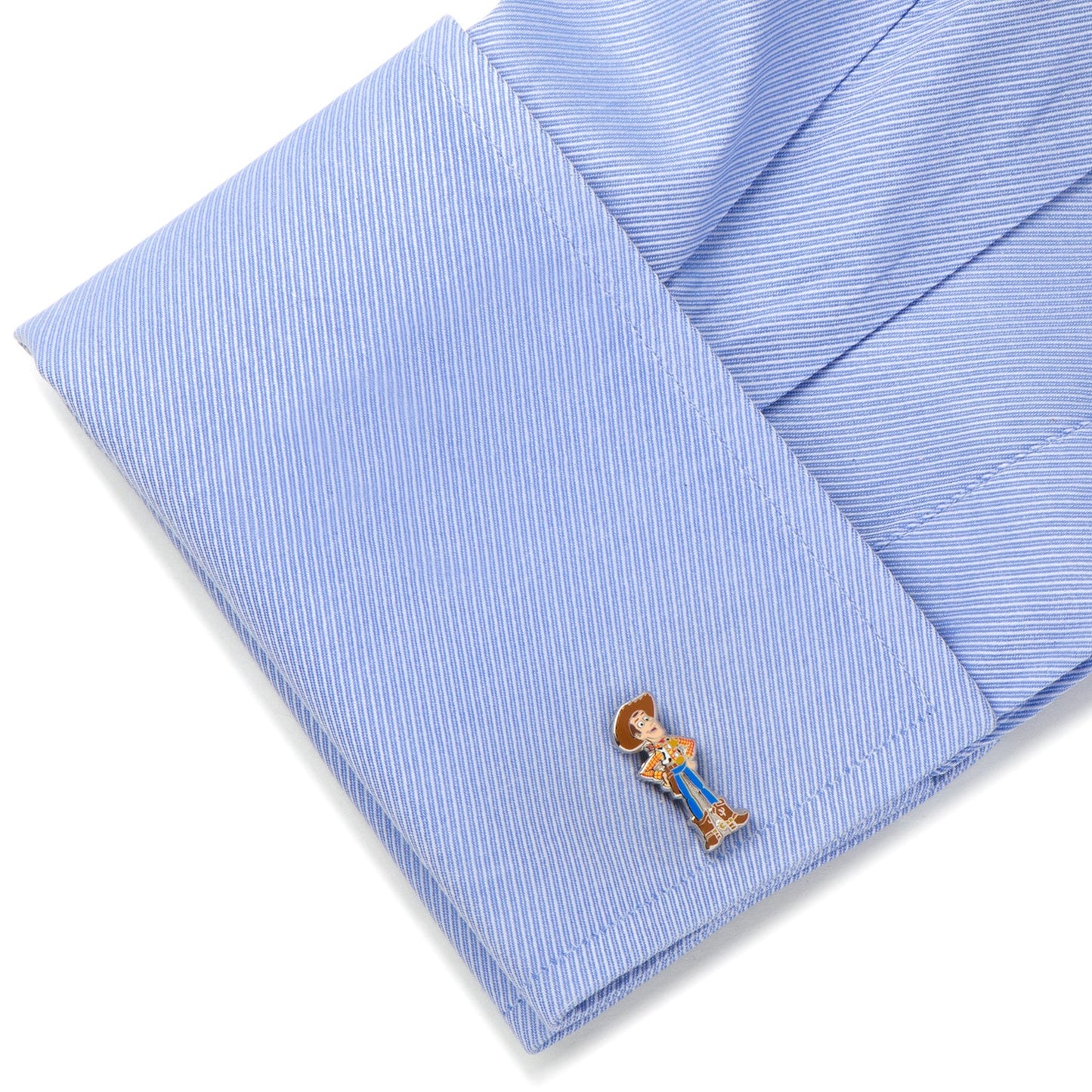 Cufflink on a folded blue striped shirt