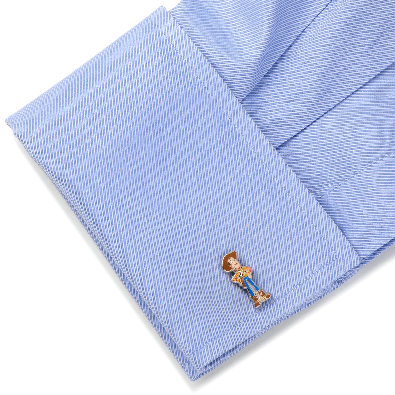 Cufflink on a folded blue striped shirt