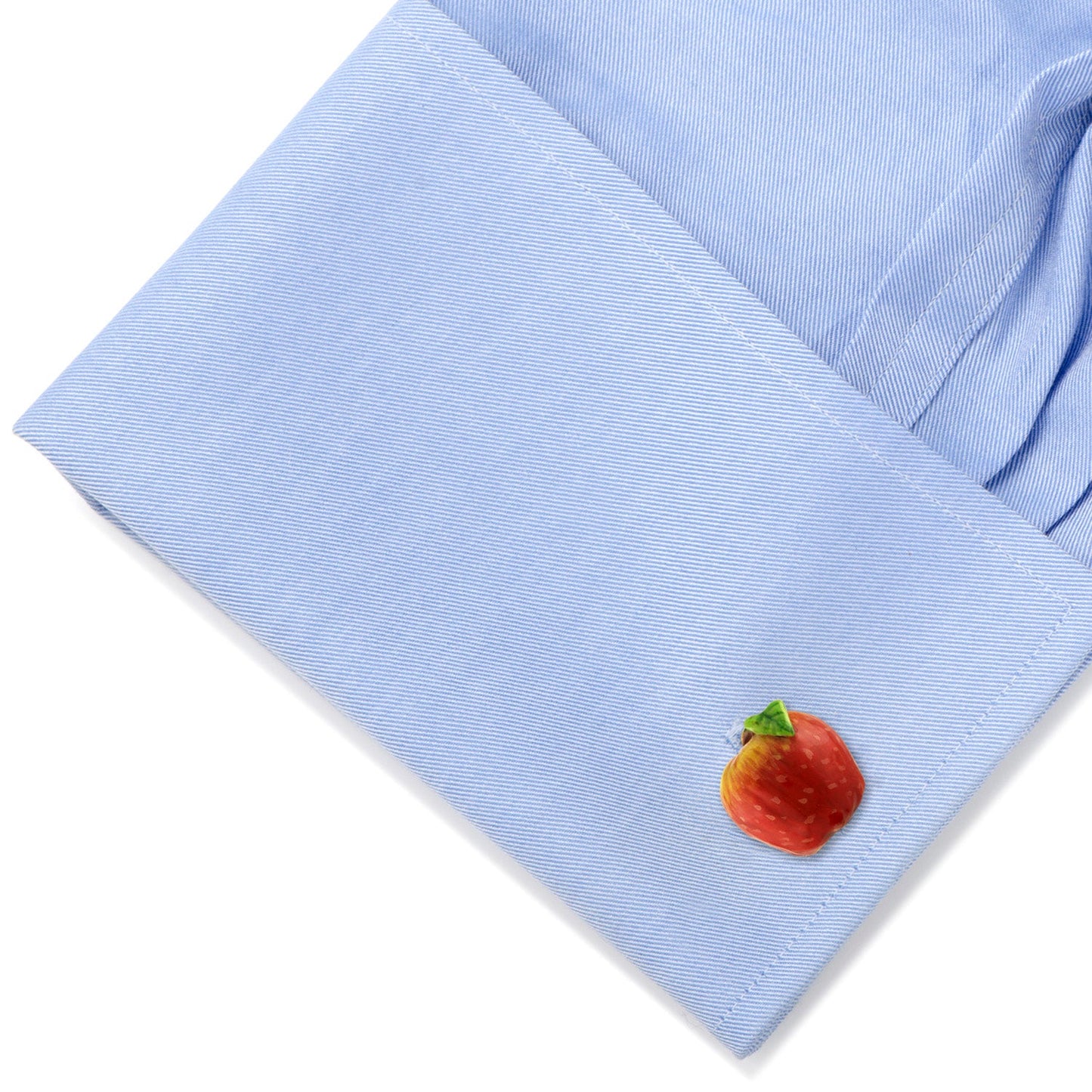 Light blue shirt cuff with a colorful apple design on a white background