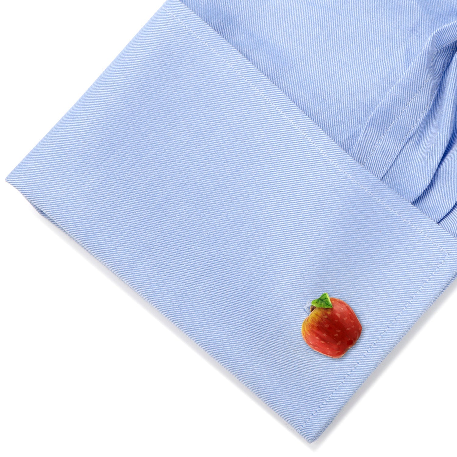 Light blue shirt cuff with a colorful apple design on a white background