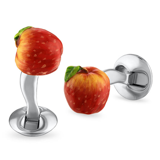 Cufflinks shaped like a strawberry and an apple on a white background