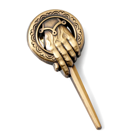 Decorative bronze hairpin with hand design on a white background
