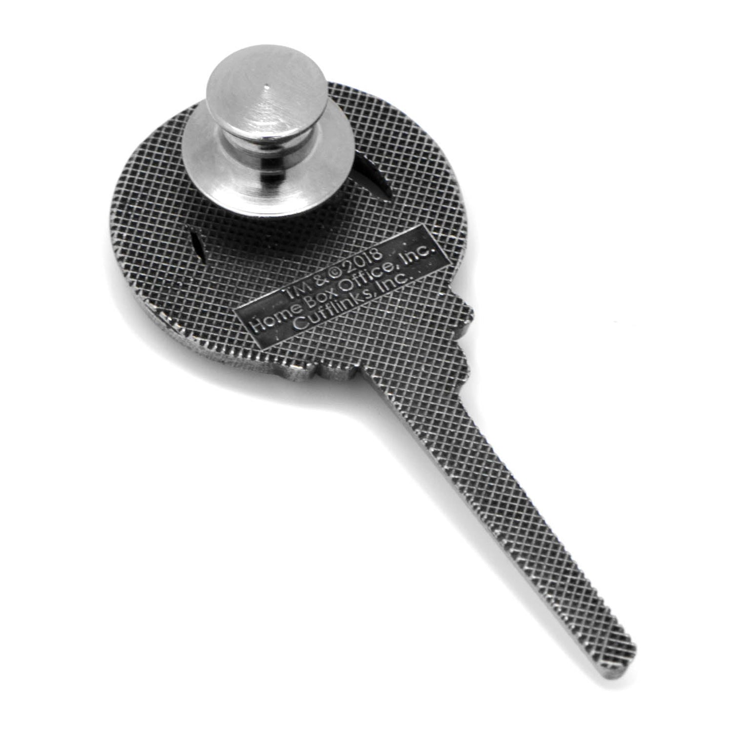 Metal key-like tool with textured surface and cylindrical head on a white background