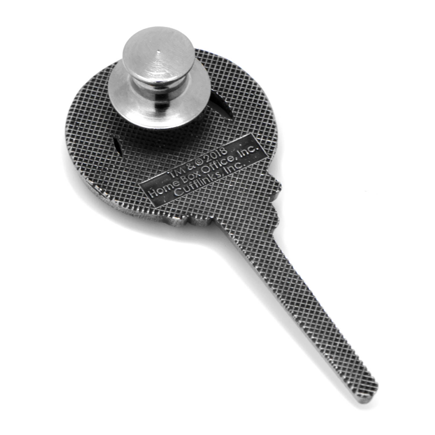 Metal key-like tool with textured surface and cylindrical head on a white background